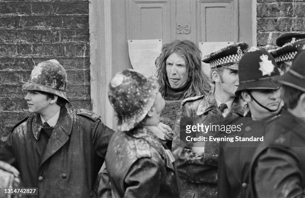 Mr David Bell is removed by the police from the house where he is 'squatting' or living illegally in London, UK, 31st May 1974.