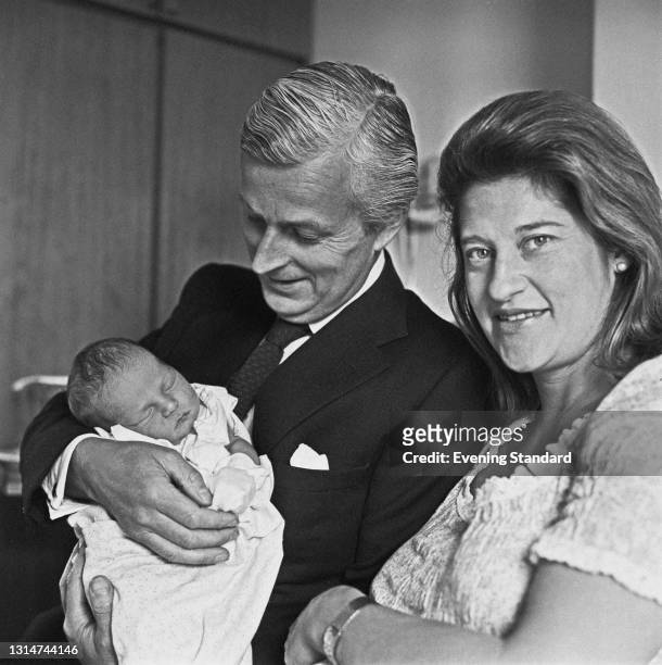 British Conservative politician Michael Grylls with his wife Sarah and their baby son Edward, known later as Bear Grylls, UK, 10th June 1974.