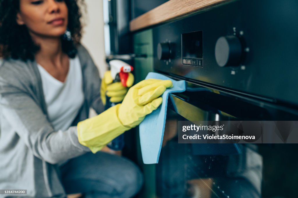 Woman wiping surface at home.
