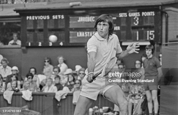 Romanian tennis player Ilie Nastase takes on Czech player Jiri Hrebec in the First Round of the Men's Singles at the Wimbledon Championships in...