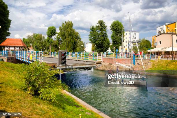 holidays in poland - sailboat passes through the luczański channel in gizycko - gizycko stock pictures, royalty-free photos & images