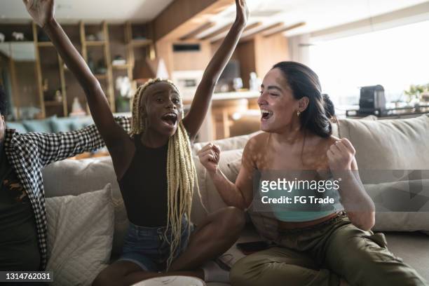 friends together watching sports on television at home - match sport imagens e fotografias de stock