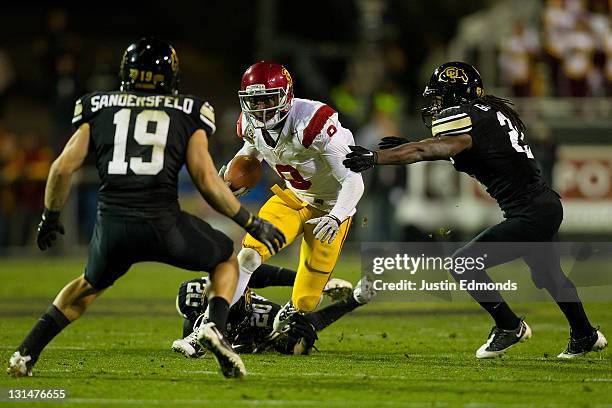 Wide receiver Marqise Lee of the USC Trojans looks to split the defense of defensive backs Travis Sandersfeld and D.D. Goodson of the Colorado...