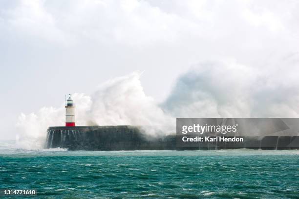 a daytime view of newhaven lighthouse in a storm - stock photo - extreme weather stock pictures, royalty-free photos & images