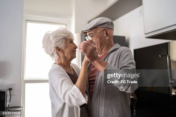 senior couple dancing at home - older couple ballroom dancing stock pictures, royalty-free photos & images