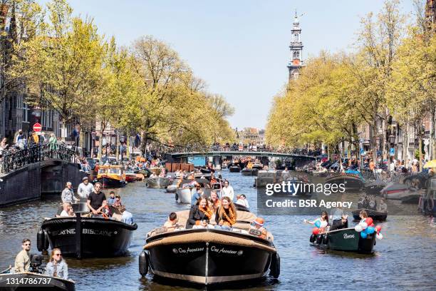 Revelers in boats are seen on the canals during King's Day 2021 on April 27, 2021 in Amsterdam, Netherlands. Due to the coronavirus pandemic, this...