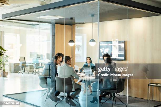 business colleagues discussing strategy at office - konferenzraum stock-fotos und bilder