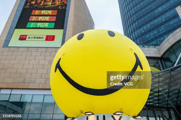 Smiley balloons are set up to advertise a Smiley Hour Pop-up store at a shopping mall on April 26, 2021 in Shanghai, China.