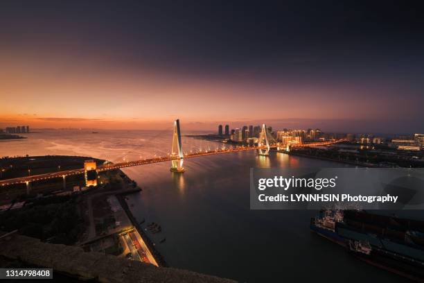 haikou centry bridge at dusk - trade agreement stock pictures, royalty-free photos & images