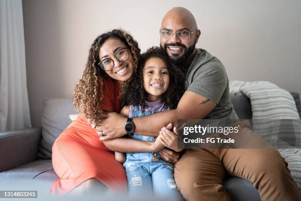 portrait of a family embracing at home - brazilian ethnicity stock pictures, royalty-free photos & images