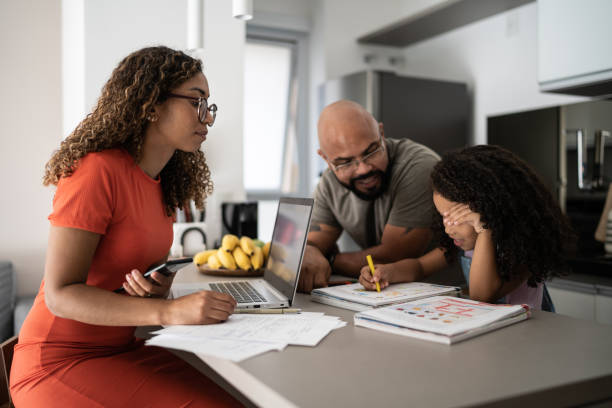 girl studying with father's support and mother working at home - black parents helping their kids in the learning process stock pictures, royalty-free photos & images