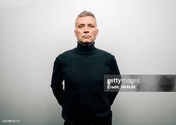 man in turtle neck t-shirt - black polo shirt stock pictures, royalty-free photos & images