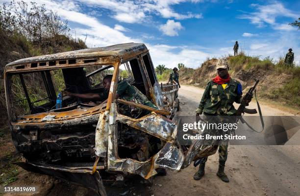 Congolese Army Soldiers inspect the site of an ADF ambush on two vehicles on April 7, 2021 in Mbaou, Beni, Democratic Republic of the Congo. The ADF...