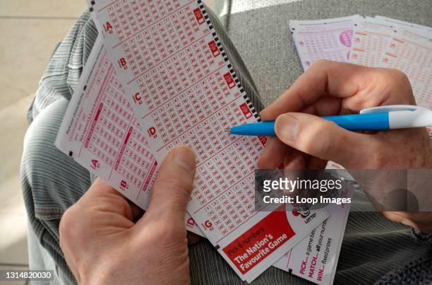 Close up of man filling in Lotto lottery slip.