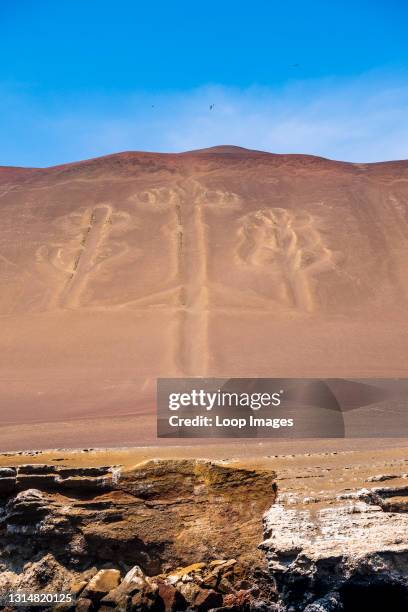 The famous Candelabra lines carved into a hillside facing the sea in Paracas.