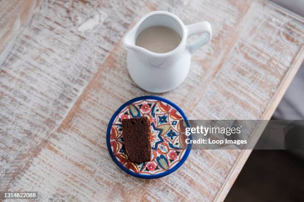 Slice of freshly made chocolate brownies with oat milk.