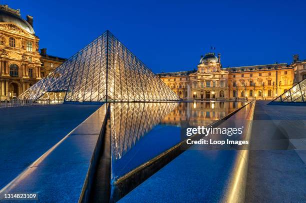 Louvre Museum and Pyramid at night Paris.