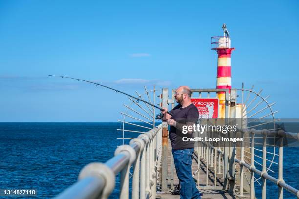 Sea fishing from a pier.