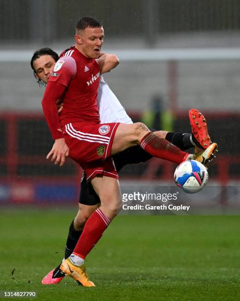 Colby Bishop of Accrington is tackled by Rasmus Nicolaisen of Portsmouth during the Sky Bet League One match between Accrington Stanley and...