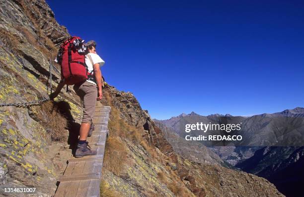 Trekker in Valnontey. Between Vittorio Sella Refuge and Leonessa Bivouac. Valnontey. Cogne Valley. Gran Paradiso National Park. Aosta Valley. Italy.