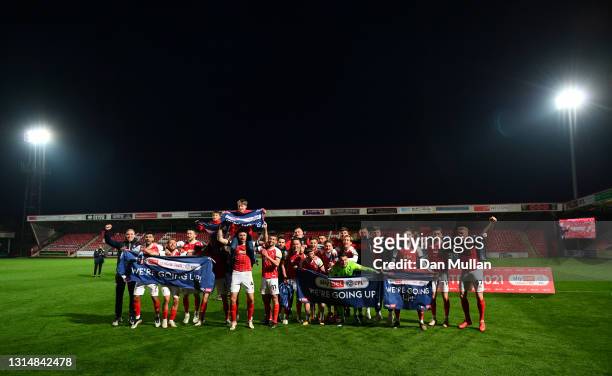 Players of Cheltenham Town celebrate their side's victory as they gain promotion to the Sky Bet League One after the Sky Bet League Two match between...