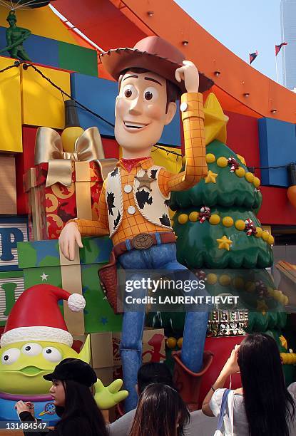 People take pictures of Disneyland's Toy Story characters outside a shopping mall in Hong Kong on November 5, 2011. Disneyland's new attraction Toy...