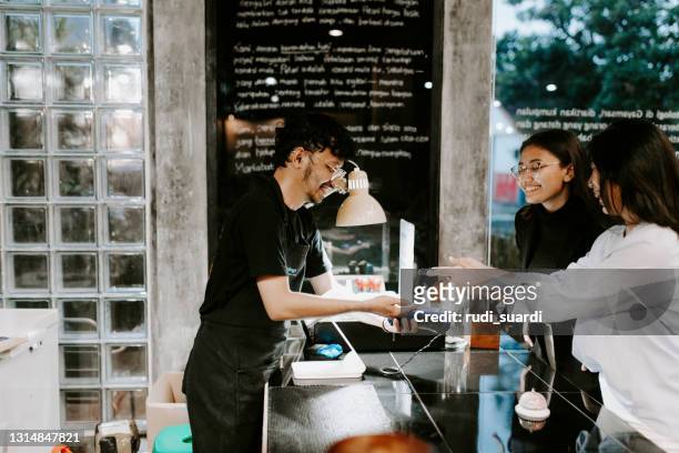 customer making a contactless payment - indonesia stock pictures, royalty-free photos & images