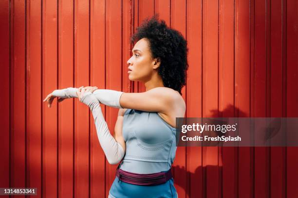 fit woman stretching after an intense workout session - sleeve stock pictures, royalty-free photos & images