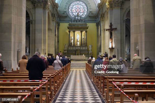 Church during the Coronavirus epidemic. COVID-19 instructions : sanitizing gel, surgical mask and social distancing during catholic mass celebration....