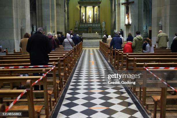 Church during the Coronavirus epidemic. COVID-19 instructions : sanitizing gel, surgical mask and social distancing during catholic mass celebration....