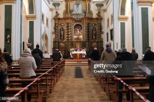 Church during the Coronavirus epidemic. COVID-19 instructions : sanitizing gel, surgical mask and social distancing during catholic mass celebration....