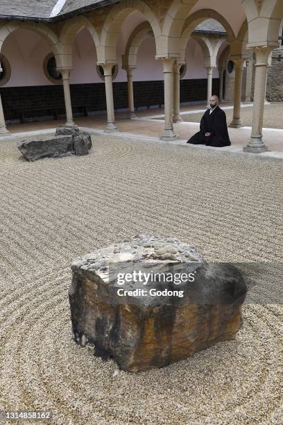 Zen buddhist monk practising zazen in Orval trappist abbey's zen garden, Belgium.