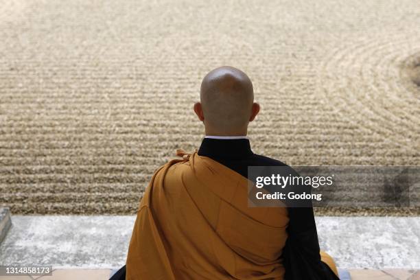 Zen buddhist master practising zazen in Orval trappist abbey's zen garden, Belgium.