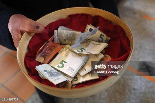 Collection during a catholic mass. Basket with Euros. Sallanches. France.