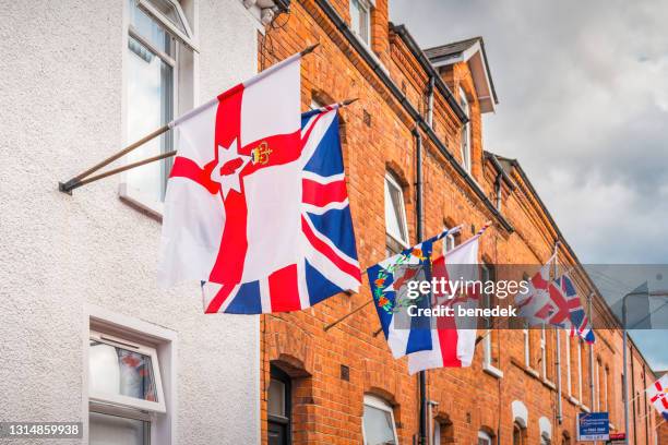 flags of northern ireland and united kingdom - northern ireland stock pictures, royalty-free photos & images