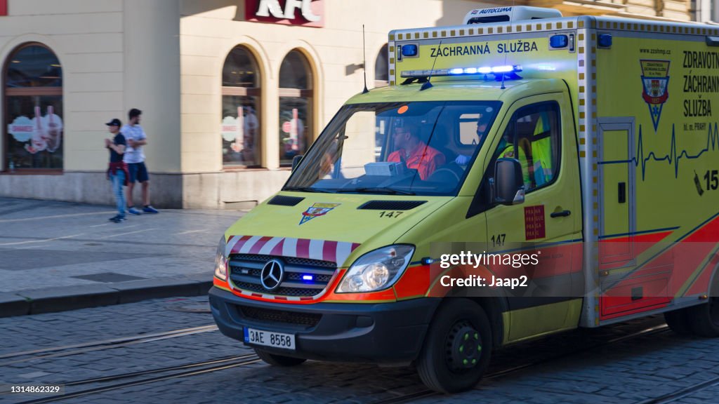 Czech ambulance responding with emergency lights in a street downtown Prague