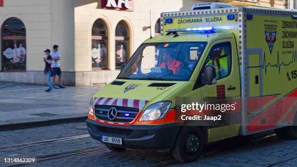 czech ambulance responding with emergency lights in a street downtown prague - ambulance approaching stock pictures, royalty-free photos & images