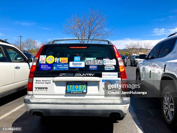 santa fe, nm: bumper stickers on parked volvo - bumper sticker stock pictures, royalty-free photos & images