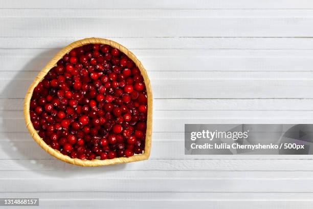 directly above shot of pomegranate seeds in bowl on table - cranberry heart stock pictures, royalty-free photos & images