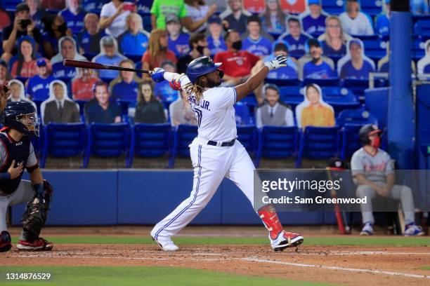 Vladimir Guerrero Jr. #27 of the Toronto Blue Jays watches his grand-slam home run in the third inning against the Washington Nationals at TD...