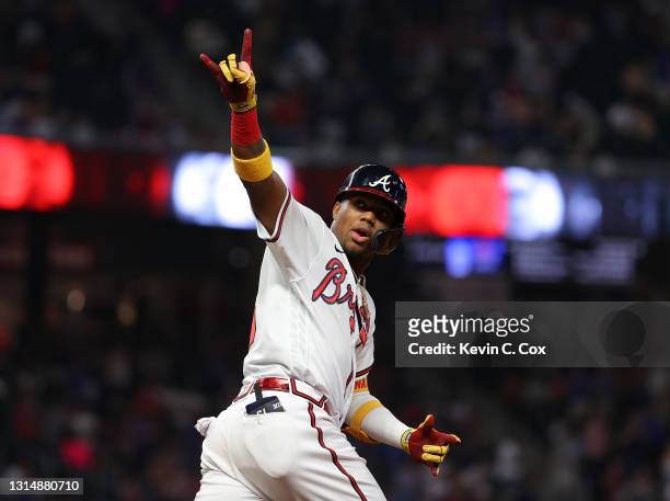 Ronald Acuna Jr. #13 of the Atlanta Braves reacts after hitting a solo homer in the fifth inning against the Chicago Cubs at Truist Park on April 27,...