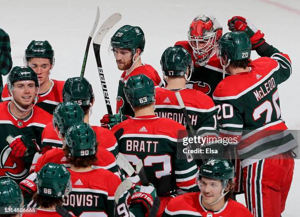 Mackenzie Blackwood of the New Jersey Devils is congratulated by teammates after the game against the Philadelphia Flyers at Prudential Center on...