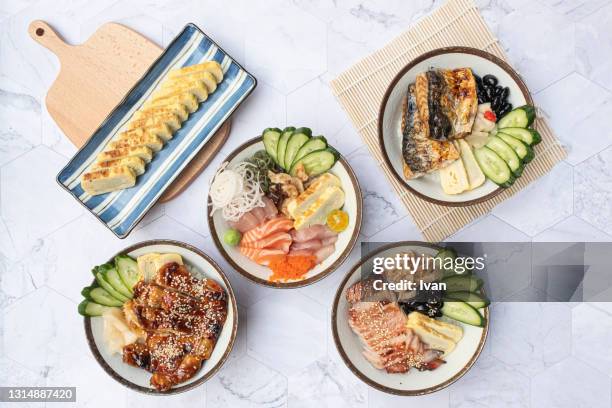 traditional japanese cuisine set, donburi rice, sashimi, grilled fish, teriyaki, sashimi and omelets - sudderen stockfoto's en -beelden