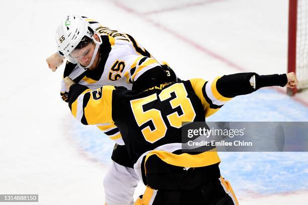 Teddy Blueger of the Pittsburgh Penguins and Jeremy Lauzon of the Boston Bruins fight in the third period during their game at PPG PAINTS Arena on...