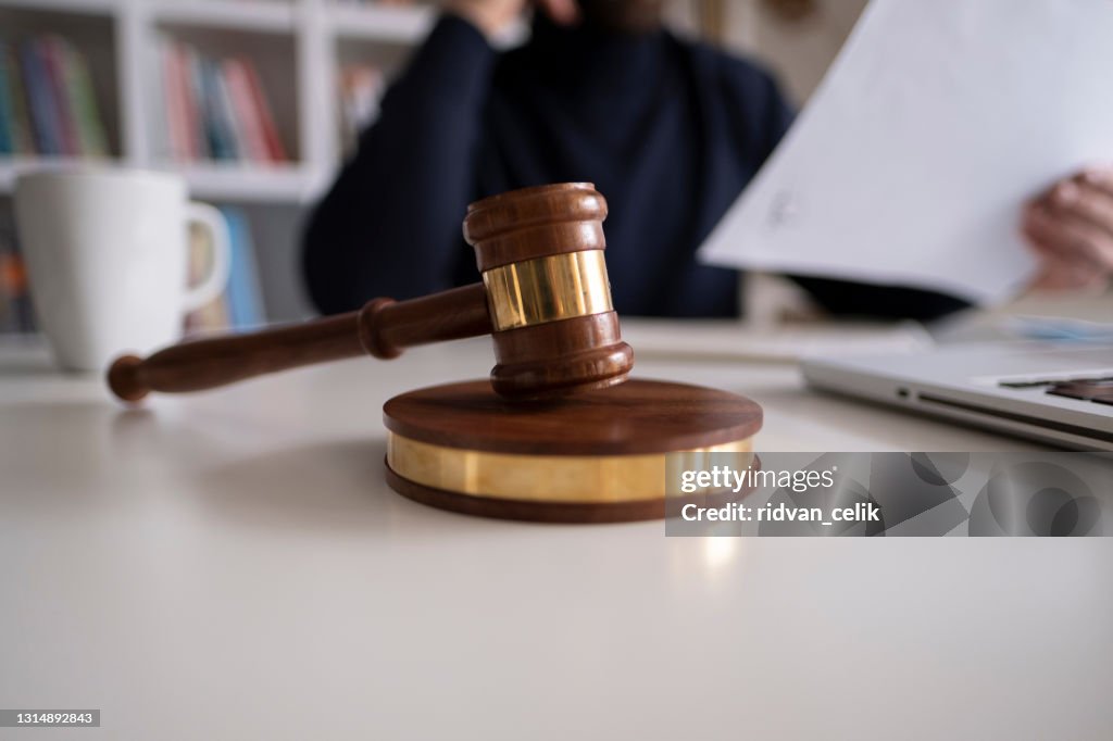 Lawyer in office with gavel, symbol of justice