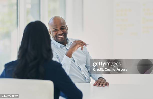 shot of two businesspeople having a meeting in an office - confident businessman sitting with colleagues in office stock pictures, royalty-free photos & images