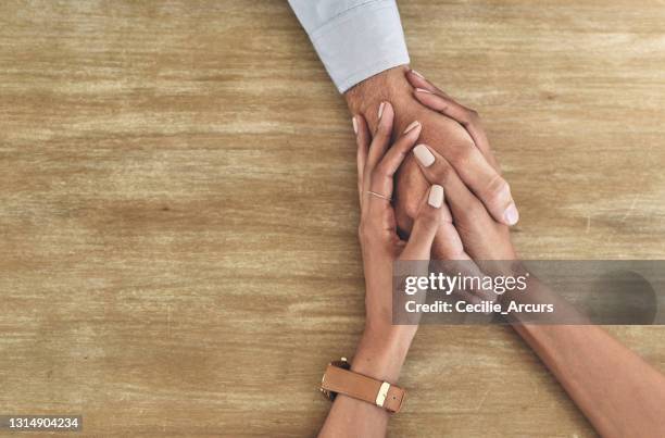 closeup shot of two unrecognisable people holding hands - im sorry stock pictures, royalty-free photos & images
