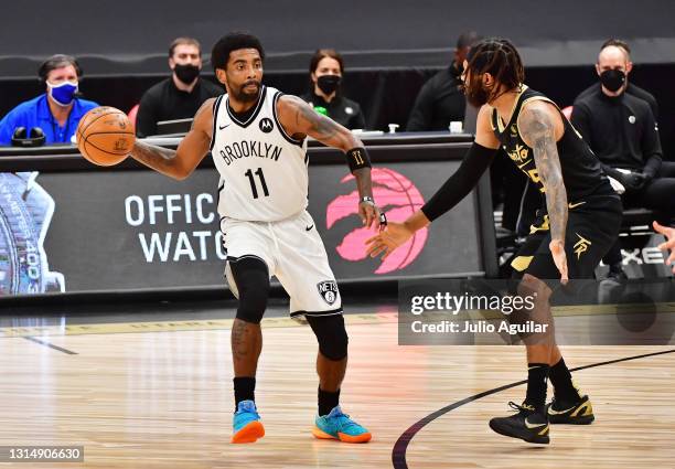 Kyrie Irving of the Brooklyn Nets looks to pass the ball against DeAndre' Bembry of the Toronto Raptors in the first half at Amalie Arena on April...