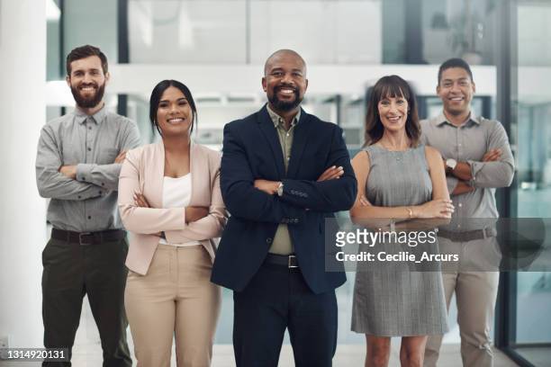 portrait of a group of businesspeople standing together in an office - organised group photo stock pictures, royalty-free photos & images
