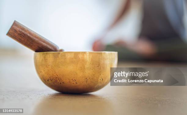 close up of a brass chant and yoga stick. - sable zen stock pictures, royalty-free photos & images